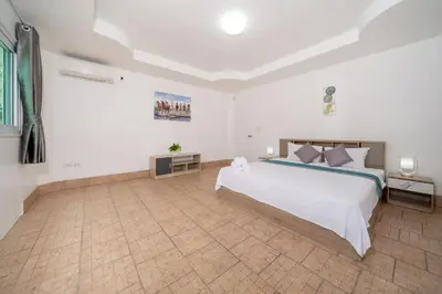 a bedroom with a large white bed in a room at Villa Olympus Ocean Vista Kata Beach in Kata Beach