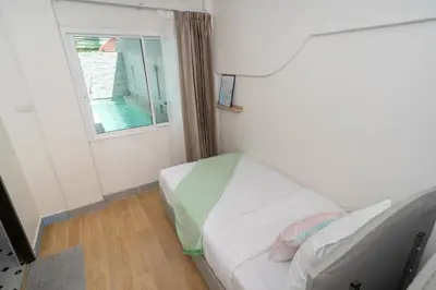 a small room with a bed and a window at Bangla Patong Pool Villas with 4 Villas different designs choose fro, photo before Book in Patong Beach
