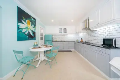 a kitchen with a table and chairs in a kitchen at Bangla Patong Pool Villas with 4 Villas different designs choose fro, photo before Book in Patong Beach