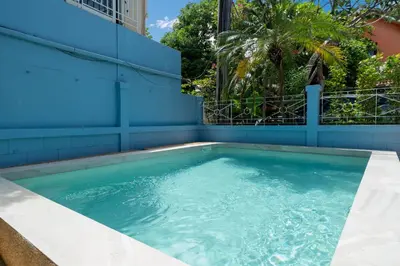 a swimming pool with blue walls and blue water at Bangla Patong Pool Villas with 4 Villas different designs choose fro, photo before Book in Patong Beach