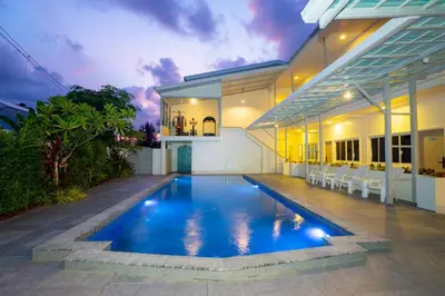 a swimming pool in the backyard of a house at Puean Chang Resort Phuket in Thalang