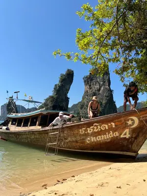 a group of people on a boat on the beach at Ban Tha Ton Do Koh Yao noi in Ko Yao Noi