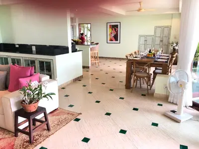 a living room with a couch and a table at Bali style 4 bedroom beachfront Villa Ao Yon in Ban Ao Makham