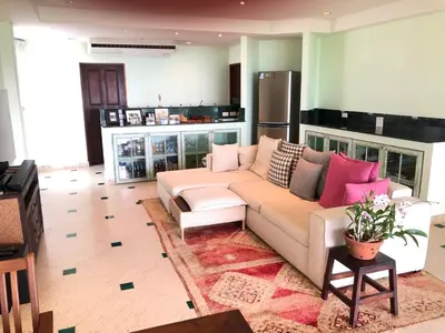a living room with a white couch and pink pillows at Bali style 4 bedroom beachfront Villa Ao Yon in Ban Ao Makham