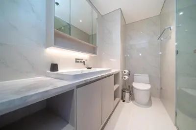 a bathroom with a sink and a toilet and a mirror at Deluxe apartment at Cassia Residences by Lofty in Bang Tao Beach