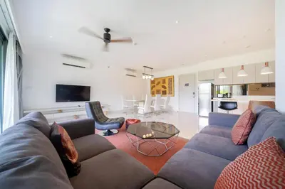 a living room with a couch and a table at Deluxe apartment at Cassia Residences by Lofty in Bang Tao Beach