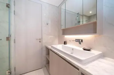 a white bathroom with a sink and a mirror at Deluxe apartment at Cassia Residences by Lofty in Bang Tao Beach