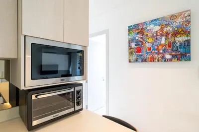 a kitchen with a tv and a microwave at Deluxe apartment at Cassia Residences by Lofty in Bang Tao Beach
