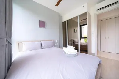 a bedroom with a large white bed with white sheets at Deluxe apartment at Cassia Residences by Lofty in Bang Tao Beach