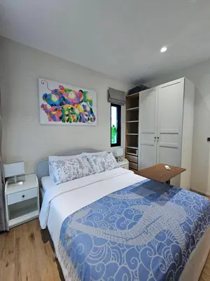 a bedroom with a large bed with a blue comforter at The Title Halo 1 Jupiter in Nai Yang Beach