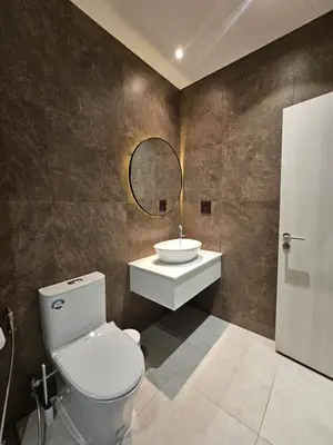 a bathroom with a toilet and a sink and a mirror at The Title Halo 1 Jupiter in Nai Yang Beach