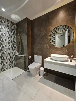 a bathroom with a toilet and a sink and a mirror at The Title Halo 1 Jupiter in Nai Yang Beach