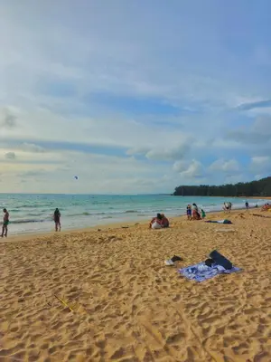 a group of people on a beach near the ocean at The Title Halo 1 Jupiter in Nai Yang Beach