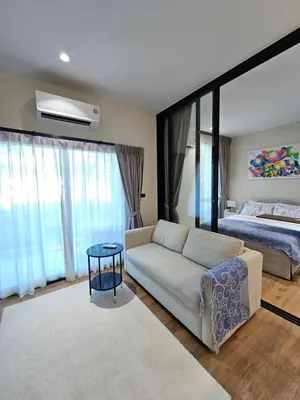 a living room with a couch and a bed at The Title Halo 1 Jupiter in Nai Yang Beach