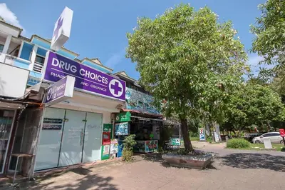 a store with a purple sign on the side of a street at OYO 1148 Aonang Andaman Resort in Ao Nang Beach