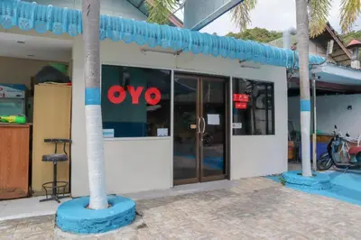 a store front with the ovo sign on the doors at OYO 681 Paradise Hotel in Ao Nang Beach