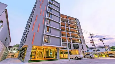 a tall building with a van parked in front of it at B2 Phuket Boutique & Budget Hotel in Ban Sam Kong