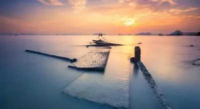 a large body of water with a sunset in the background at The Royhanna Beach House in Tab Kaek Beach