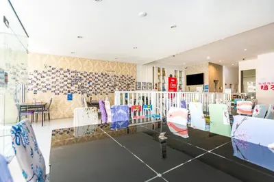 a room with a table and chairs in a room at OYO 472 Tang Cheng Holiday Hotel in Patong Beach