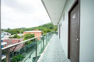 a balcony with a view of a building at OYO 259 Baan Napatr in Ban Thalat Choeng Thale