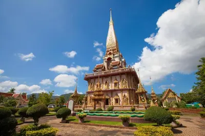a large building with a tower in a park at OYO 422 Jane Homestay and Resort in Ban Kata
