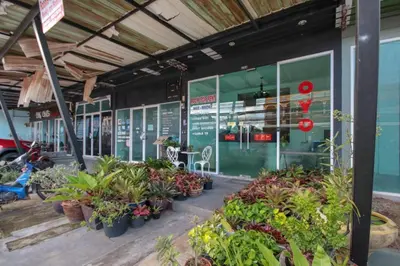 a store with a bunch of plants in front of it at OYO 1162 Chalong Home Place in Ban Klang