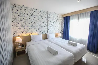 a bedroom with a large bed with two pillows on it at Ocean and Ole Patong in Patong Beach