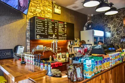 a bar with a person sitting behind the counter at Ocean and Ole Patong in Patong Beach