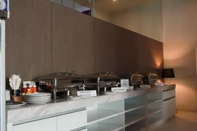 a counter with pots and pans on top of it at Elegancy Sansabai Hotel in Patong Beach