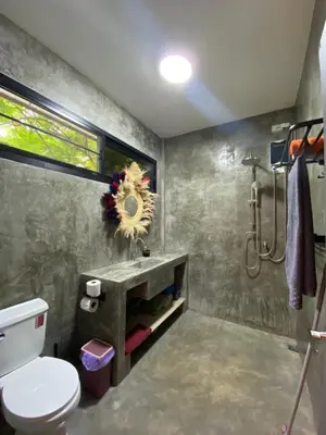 a bathroom with a toilet and a sink at Lakshmi beach house in Phuket Town