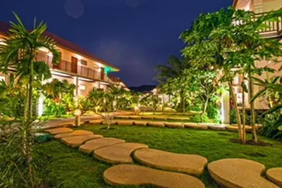 a garden with a stone path in the grass at Blue Koh Yao Yai Resort and Villa in Ko Yao Yai