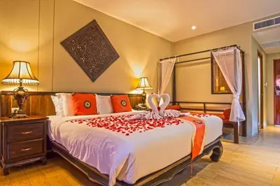 a bedroom with a large bed with roses on it at Blue Koh Yao Yai Resort and Villa in Ko Yao Yai