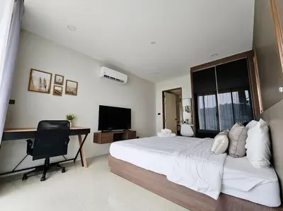 a bedroom with a bed and a desk and a television at Seaview room nice sunset Patong in Patong Beach