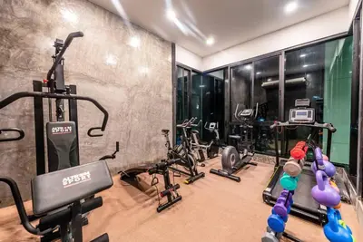 a gym with several exercise bikes in a room at Seaview room nice sunset Patong in Patong Beach