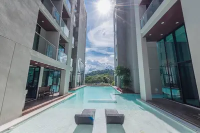 a swimming pool in the middle of a building at Seaview room nice sunset Patong in Patong Beach