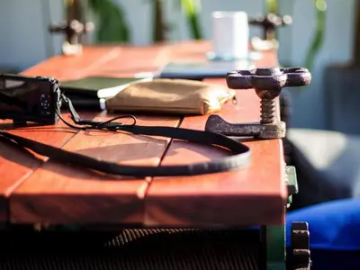 a wooden table with a telephone on top of it at Mini Boxtel Aonang Hostel in Ao Nang Beach