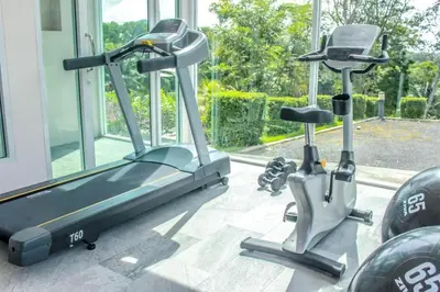 two exercise bikes sitting next to a window in a gym at Royal Lee Resort and Spa in Ban Bo Han