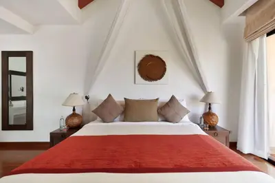 a bedroom with a large bed with a red blanket at Laguna Fairway View Villa in Bang Tao Beach