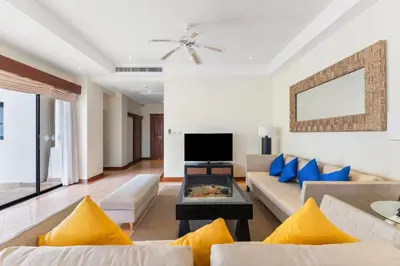 a living room with two couches and a tv at Laguna Fairway View Villa in Bang Tao Beach