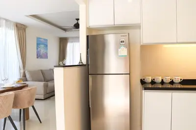 a kitchen with a stainless steel refrigerator in a room at Super Friendly TH Laguna Park in Phuket Town