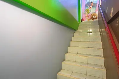 a stairway with a teddy bear sitting on the top at OYO 586 I Hostel Phuket in Ban Ket Ho