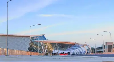 a large building with a soccer field in front of it at At night Airport Resort in Ban Bo Han