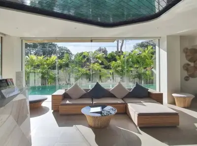 a living room with a couch and a pool at Stunning sea view apartment with pool in Ao Nang Beach