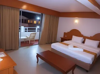 a hotel room with a large bed and a window at Hack Patong Beach Hotel in Patong Beach