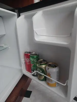 a refrigerator door open with cans of soda andadobeadobeadobeadobeadobeadobeadobe at Hack Patong Beach Hotel in Patong Beach