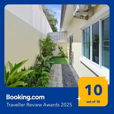 a house with a sign that reads traveller review awards at Spacious Family Garden Villa - Huge Pool & Gym Access in Thalang