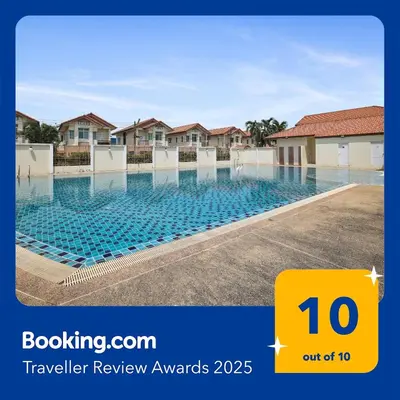 a swimming pool in front of some houses at Spacious Family Garden Villa - Huge Pool & Gym Access in Thalang