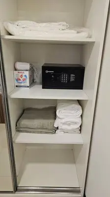 a white closet with towels and a towel at Новая квартира с выходом к бассейну in Mai Khao Beach