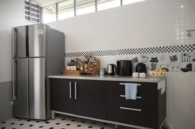 a kitchen with a stainless steel refrigerator at Grand Chalong Family House in Chalong