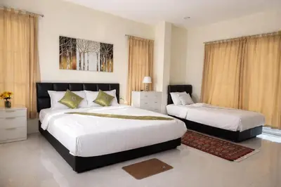 a bedroom with two beds in a room at Grand Chalong Family House in Chalong